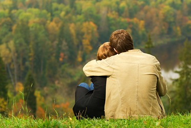 bigstock-Sweet-couple-sitting-on-a-hill-13194563