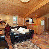 The sitting room in the Earth House with gourmet kitchen in back ground.
