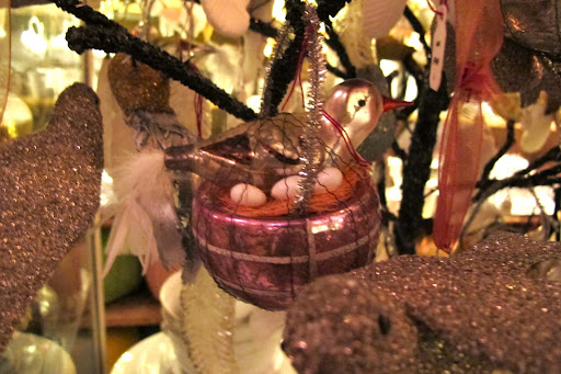 A tiny bird with its eggs in a nest. Finding ornaments in any tree, especially the ones tucked way back, is part of the decorative fun.