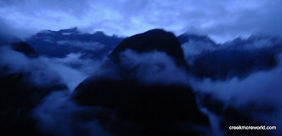 The mountainous could forest of the Sacred Valley, Peru in an erie blue light of dawn.