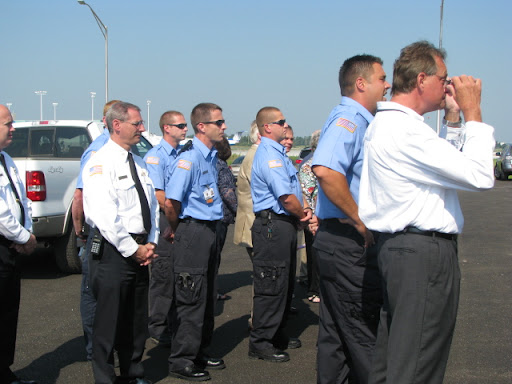 Fire fighters watch the dedication of the new building.