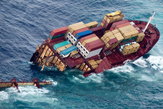 Half of the grounded container ship 'Rena' is seen in the Bay of Plenty near Tauranga on 9 January 2012, after it broke in two in a storm. The cargo ship which caused New Zealand's worst maritime pollution disaster when it ran aground three months ago broke in two in a storm on January 8, raising fears of a fresh environmental crisis. Marty Melville / AFP / Getty Images