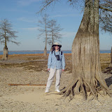 Julie stands next to a tree to show the extent of the drought.