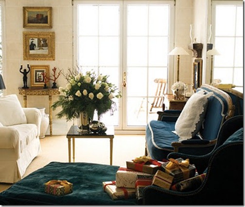 habitually chic living room with white flowers and evergreens