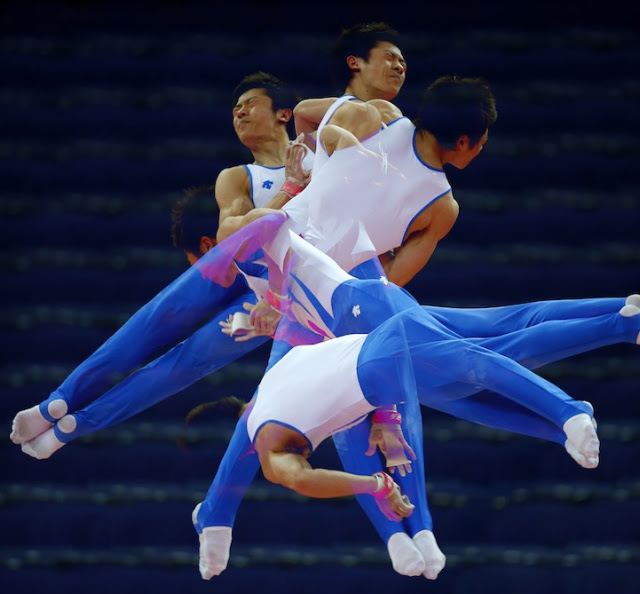 South Korea's Kim Soo-myun rotates above the horizontal bar during men's gymnastics podium training before the 2012 London Olympic Games in London July 25, 2012. Picture taken with multiple exposures.  REUTERS/Mike Blake  (BRITAIN - Tags: SPORT OLYMPICS GYMNASTICS) ORG XMIT: MB06