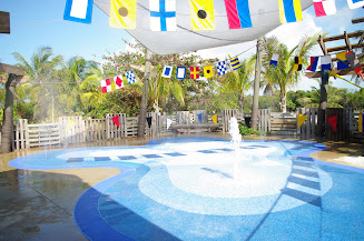 There are places for adults to sit and watch the little ones splashing in the water.