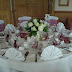 Table decorated with simpe cream roses, chair covers & table runners.jpg