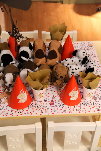 Here, the table is decorated with the placemats, puppies from Oriental Trading, hats and cups deocrated with my illustrations, and chairs with dogs on them from IKEA.