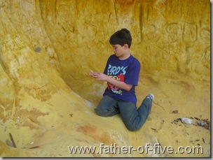 Sifting through the fine sand of the cave.