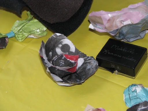 One of the brooches Davis makes out old newspaper.