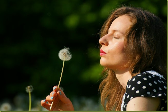 making a wish with dandelions