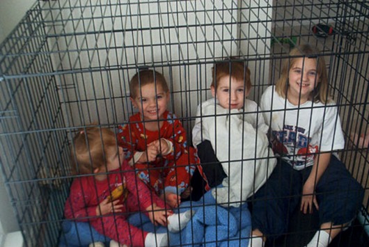 four-kids-in-dog-cage
