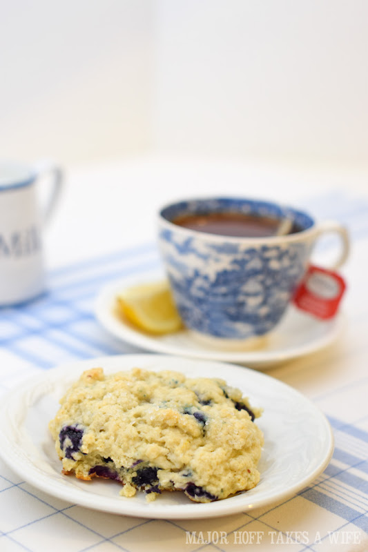 Have a blueberry scone with your cup of tea during High Tea. A melt in your mouth recipe for blueberry scones. Inspired by Starbucks in house version, this blueberry scone with hints of lemon and a crunchy sugary top will delight everyone. Serve during High Tea, or just as a mid afternoon snack. Perfect along side tea or coffee, or as a stand alone blueberry dessert. You won't believe how easy these are to make! Never made scones before? Never fear, this includes a step by step tutorial on how to make scones. #HighTea #blueberries #Starbucks #scones #dessert #DowntonAbbey Have a blueberry scone with your cup of tea during High Tea