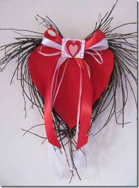 Red felt heart wreath with red ribbon bow.