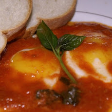 Eggs with a tomatoe and Bazil sauce.