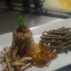 Twice cooked chicken, sides of dirty rice,Made caramelized (made sweet) onions