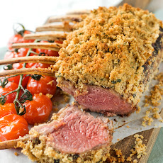 Maple and Dijon Marinated Herb-crusted rack of lamb with roasted tomatoes