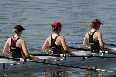 three rowers in boat