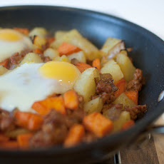 Smoky Sweet Potato Hash With Baked Eggs and Manchego