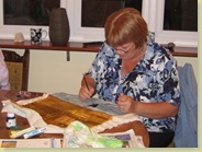 Sue used dark purple to paint the trees and bushes