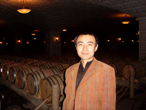 Gansu Foreign Affairs Office staff member Mr Kang standing in Zixuan Winery's wine cellar