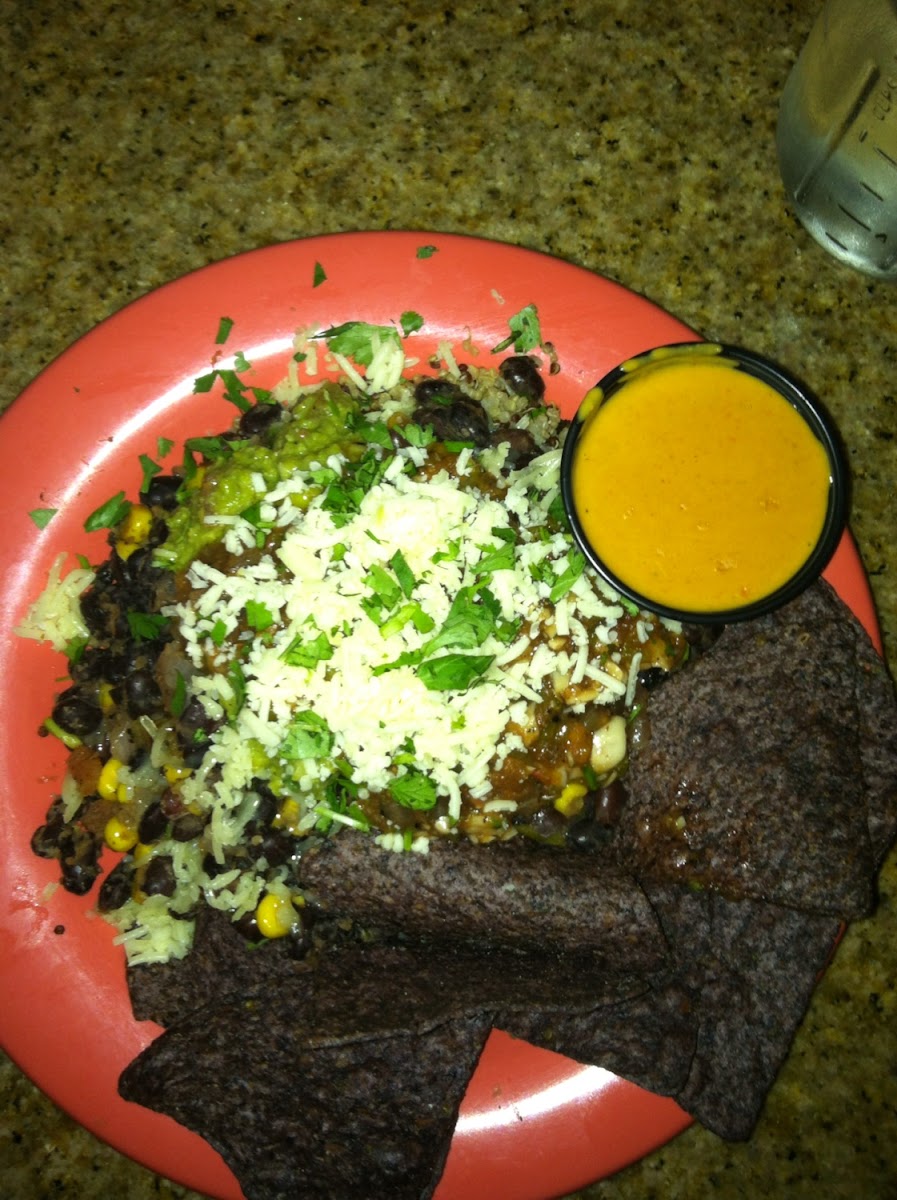 Black bean burrito bowl with quinoa and a side of queso.