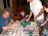 Jay helping by pouring water in a cup.