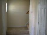 To the left the front door, to the right the hall closet, straight ahead stairs.