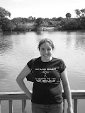 Black and white of Katie by the river.