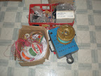 Spools of wiring, boxes of parts and coin counting machine.