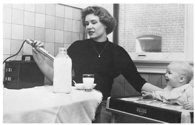 In this 196D photo, a mother tests her son's milk for signs of radioactivity, the result of nuclear weapons testing during the 19 50s that involved the radioactive isotope strontium-9 0. The isotope fell to earth in a fine powder, where it coated the grass, was ingested by cows, and eventually wound up in the milk they produced. 