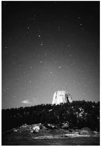 Devils Tower, with the Big Dipper visible in the night sky. 