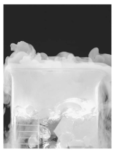 Dry ice (solid carbon dioxide), seen here being converted into a vapor, often is used to change supercooled water in clouds into ice crystals in the weather modification technique called cloud seeding.