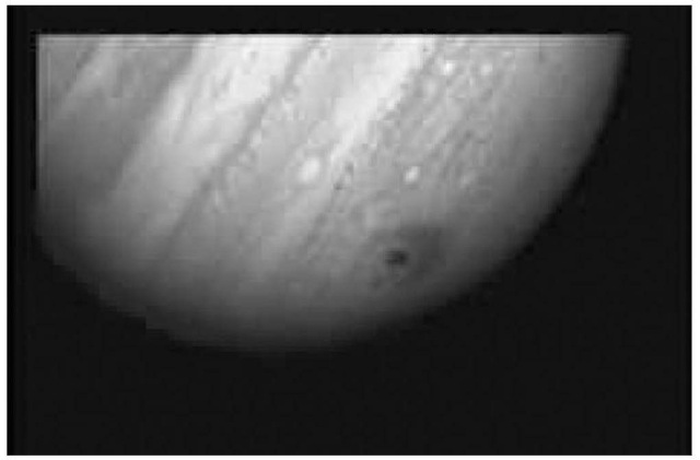 Impact zone of a large fragment of comet Shoemaker-Levy 9 in the atmosphere of Jupiter, as observed by Hubble in July 1994. The crescent pattern of ''soot'' floating high above Jupiter's cloud tops is roughly the diameter of Earth. This figure is available in full color at http://www.mrw.interscience.wiley.com/esst.