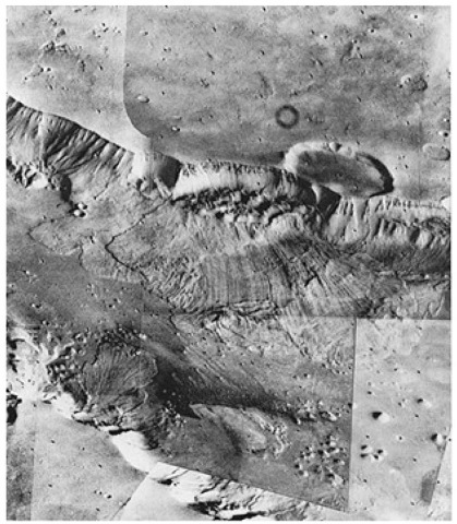 View taken by Viking 1 on July 3,1976 from a range of 2000 kilometers (1240 miles), looking southward across Valles Marineris. This huge equatorial canyon is about 2 kilometers (1.2 mile) deep. The area shown is 70 kilometers (43 miles) by 150 kilometers (94 miles). Aprons of debris on the canyon floor indicate how the canyon may have enlarged itself. The walls appear to collapse at intervals to form huge landslides that flow down and across the canyon floor. Linear striations on the landslide surface show the direction of flow. On the canyon's far wall in this view, one landslide appears to have ridden over a previous one. Streaks on the canyon floor, aligned parallel to the length of the canyon, probably are evidence of wind action. Layers in the canyon wall indicate that the walls are made up of alternate layers of lava and ash or wind-blown deposits. 