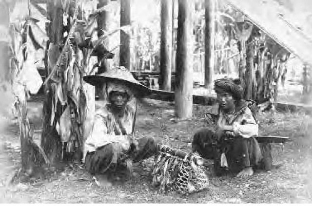 Two Kachin tribesmen near Bhamo, Myanmar (Burma), photographed around 1886. The man on the right is armed with a dha, the traditional sword used for the practice of thaing. 