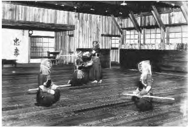 Practitioners of kendo, the Japanese Way of the Sword, practice their moves with bamboo swords in a dojo in Japan, ca. 1920.