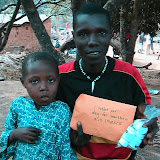  &ndash; Abu and his son, holding medicines received from Nazareth House (James Mansaray, photographer)