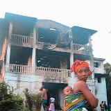  &ndash; Kadijah outside of fire damaged home. A young girl lost her life in this fire, Dec. 2006 (picture taken by James Mansaray)