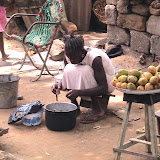  &ndash; Woman cooking what she can to eat, also selling from her outside store. Freetown. May 2007 (James Mansaray, photographer)