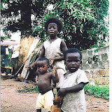  &ndash; These children live under the propped up metal sheeting you see in the background. (V. Hicks, photographer, 2003)