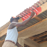  &ndash; Pa Foday painting the outside of the school…. © 2008 NHA Media Photos