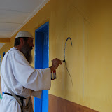  &ndash; Fr. Seraphim paints NHA Logo/Trade Mark on the Kabala School Building...© 2008 September Nazareth House Apostolate Media, James B. Mansaray, photographer.