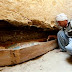 An Egyptian worker brushes an ancient Pharaonic sarcophagus of, Isis Her Ib, Illahun mayor's daughter, dated to the 22nd Dynasty (ca. 931-725 BC) inside a rock-cut tomb which has been discovered by an Egyptian archaeological mission sponsored by the Supreme Council of Antiquities (SCA) southeastern part of the pyramid field of Illahun, Sunday April 26, 2009, in Egypt's Fayoum region. (AP Photo/Amr Nabil)