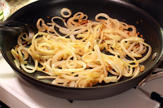 picture of onions and garlic sauteing in pan