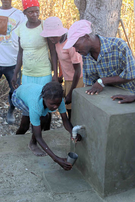 Clean water flows from a community fountain in Zabriko Haiti