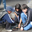 Shoe shine boy showing his “replacements” how to shine shoes