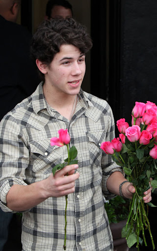 02-02-10 Sherman Oaks, CA  Nick Jonas performed a solo show for his fans outside of Mark's Garden flower shop in Sherman Oaks. After the show, he handed out roses to all the girls in attendance. Like a typical teenager, Nick has a few zits on his face.  NON-EXCLUSIVE PIX by Flynet ©2010 818-307-4813  Nicolas