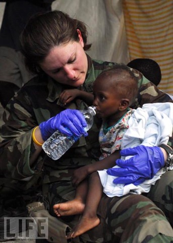 [US Navy Chief Hospital Corpsman Rioni, gives water to a dehydrated child after the devastating Haiti earthquake[3].jpg]