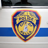 Badge on the side of a Pella Police cruiser